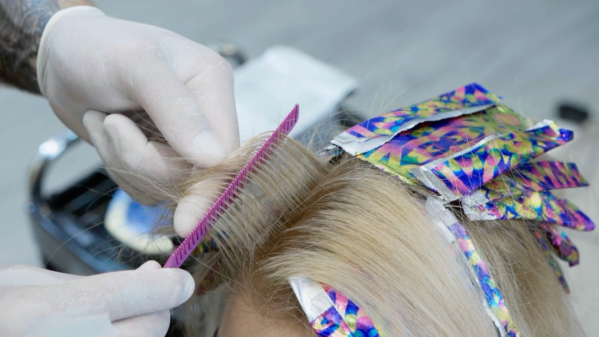 Colorist working with Vellen Hair foil and a highlighting comb